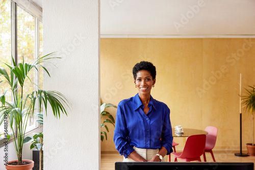 Positive black executive director in blue blouse photo
