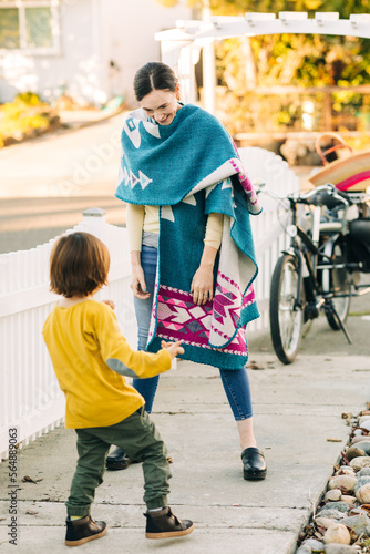 Happy mom and little son meeting at neighborhood photo