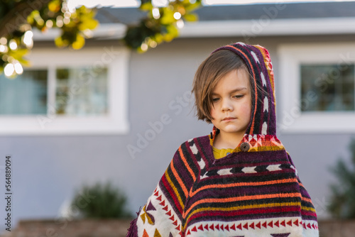 Gorgeous boy with poncho in front yard photo