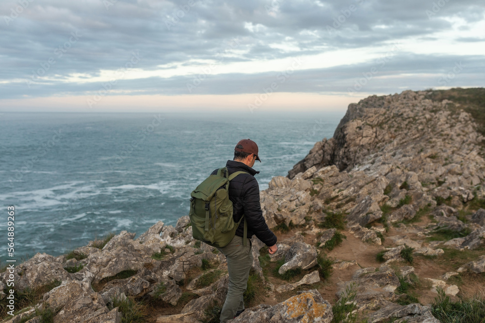 traveler man on top of a mountain by the sea traveler man on top of a mountain by the sea