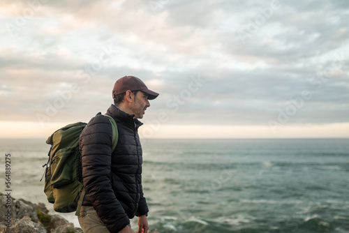 traveler man on top of a mountain by the sea photo