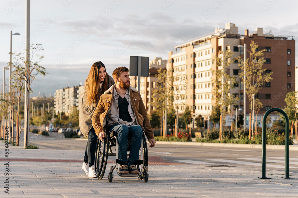 © Santi Nuñez/Stocksy - Happy Woman Helping his Handicap Boyfriend