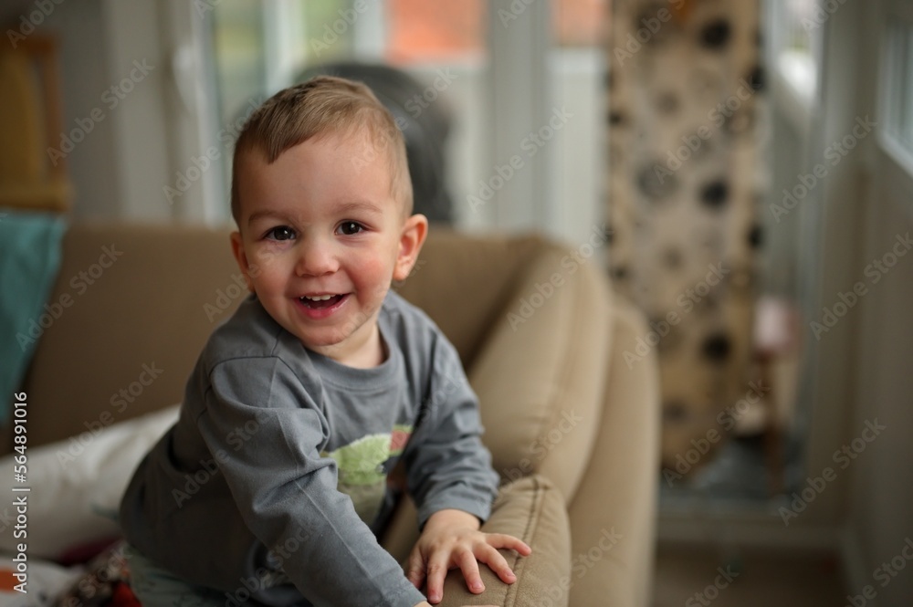 Portrait of cute little toddler sitting on a sofa Portrait of cute little toddler sitting on a sofa