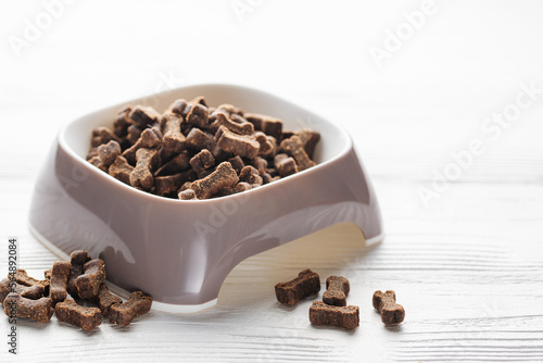 Foto A bowl of dog food on a wooden floor.