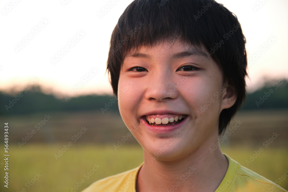 Closeup portrait of a young Asian girl next to a rice field Closeup portrait of a young Asian girl next to a rice field