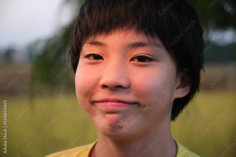 Closeup portrait of a young Asian girl next to a rice field Closeup portrait of a young Asian girl next to a rice field