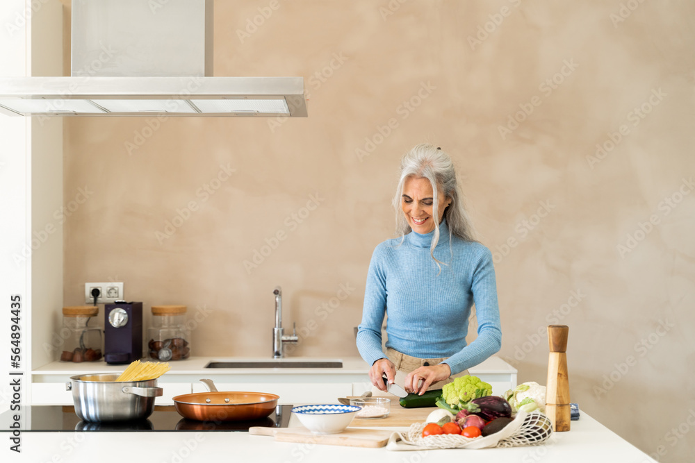 Mature woman cooking at kitchen home Mature woman cooking at kitchen home