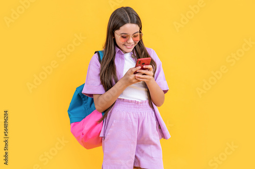 teen school girl chat isolated on yellow. teen school girl chat in studio. teen school girl chat