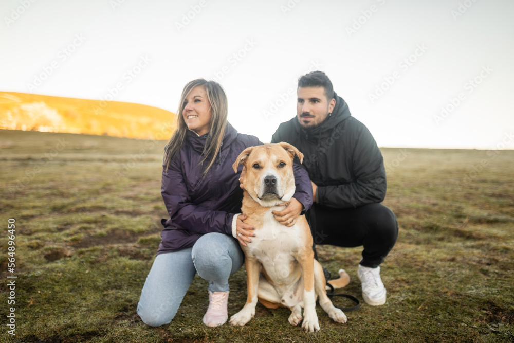 young couple in nature with their dog young couple in nature with their dog