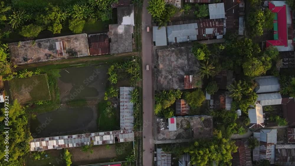 Road goes through suburban slum town. Aerial top down descending view Road goes through suburban slum town. Aerial top down descending view