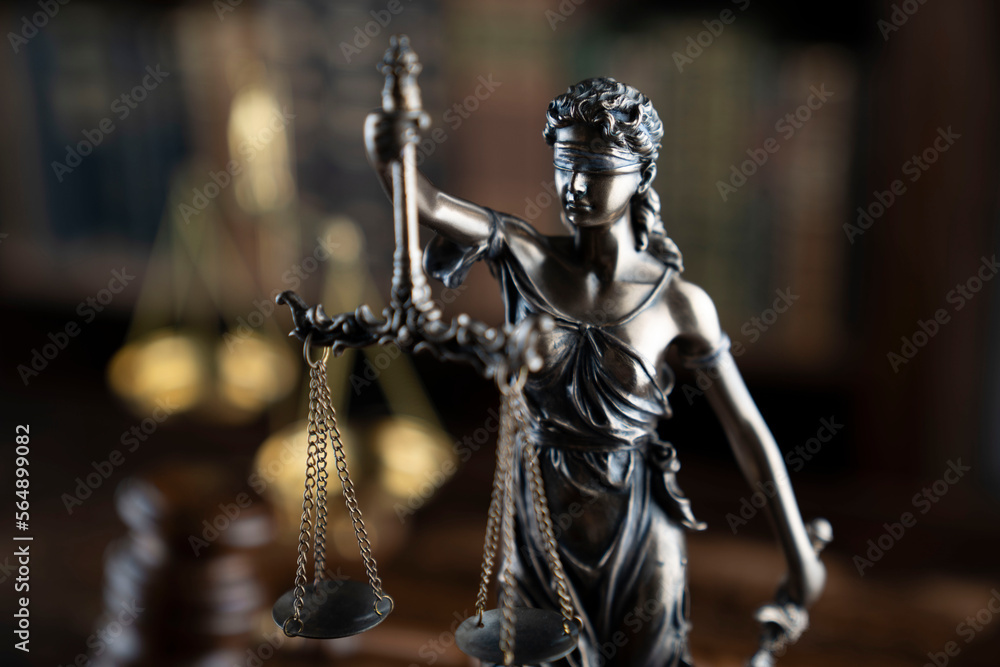 Law theme. Judge chamber. Judge’s gavel, Themis sculpture, scale and collection of legal books on the brown desk. Law theme. Judge chamber. Judge’s gavel, Themis sculpture, scale and collection of legal books on the brown desk.