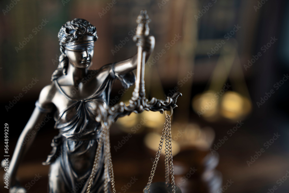 Law theme. Judge chamber. Judge’s gavel, Themis sculpture, scale and collection of legal books on the brown desk. Law theme. Judge chamber. Judge’s gavel, Themis sculpture, scale and collection of legal books on the brown desk.