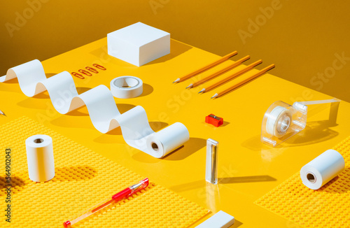 Neatly organised stationery on yellow.