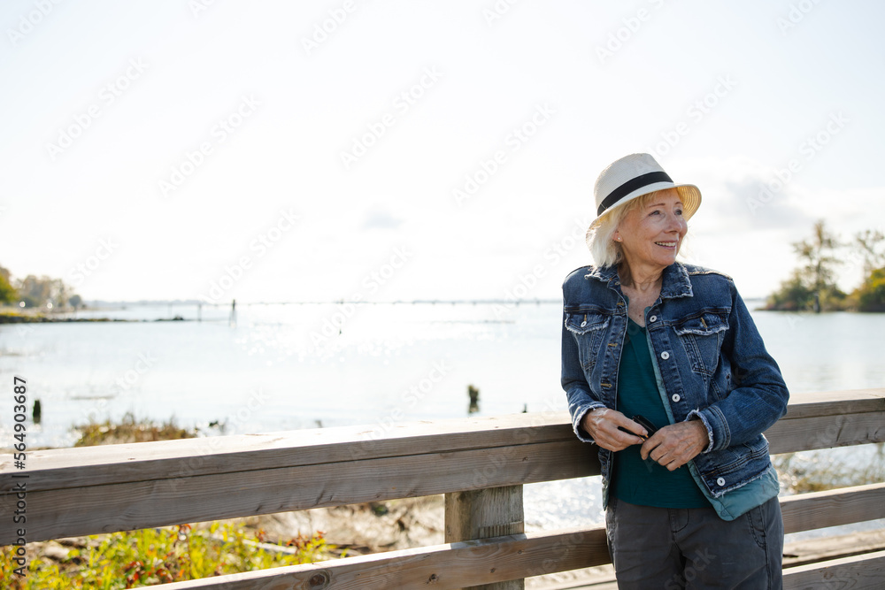 Senior woman outside in sun looking thoughtful. Senior woman outside in sun looking thoughtful.