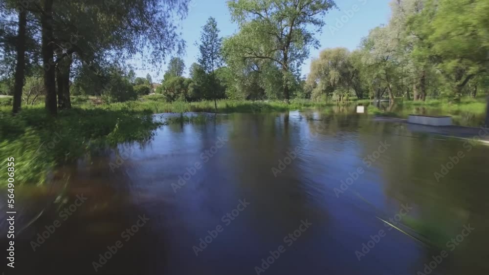 The Flooded River Covered The Winding Walkway. Low Pull-Away Aerial Shot. The Flooded River Covered The Winding Walkway. Low Pull-Away Aerial Shot.