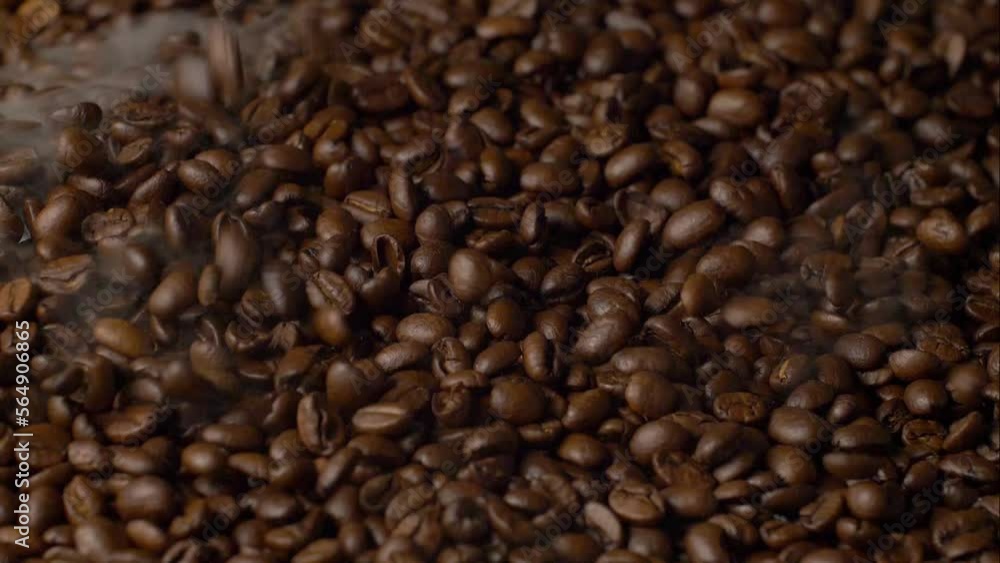 Aromatic coffee beans are poured slowly. Aroma of coffee Aromatic coffee beans are poured slowly. Aroma of coffee