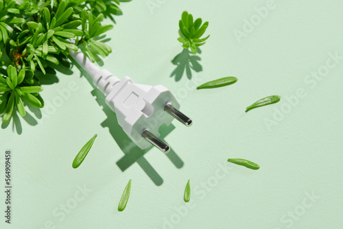 Electrical plug with leaves like a plant. Eco, bio, energy photo
