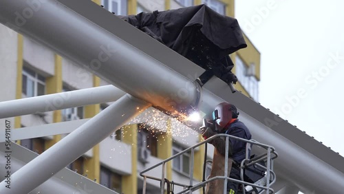 

welder who connects a metal bridge