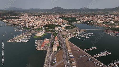 Olbia - Italy - Sardinia - 10 June 2022. Aerial view of the touristic and industrial port with line ferries in the harbour and urban panorama of the city photo