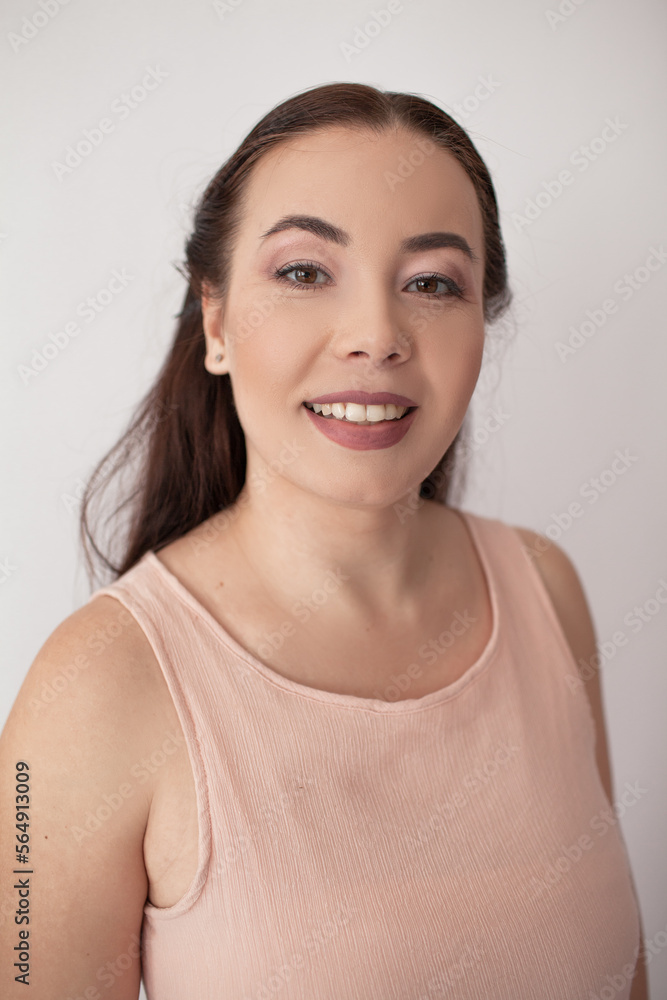Portrit of plus size asian woman with make-up against the white wall background Portrit of plus size asian woman with make-up against the white wall background