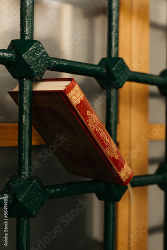 red book on a metal window fence photo