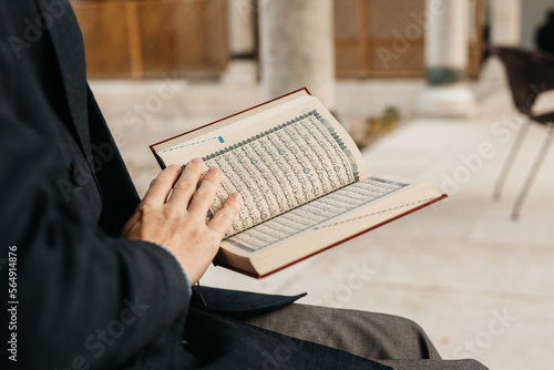 man holding Quran
