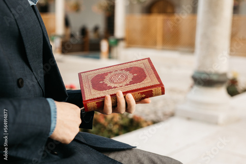 man holding Quran photo