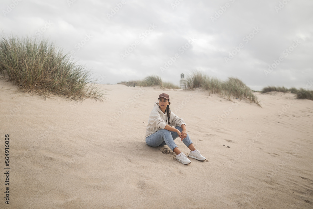 young woman on the beach a cloudy autumn day young woman on the beach a cloudy autumn day