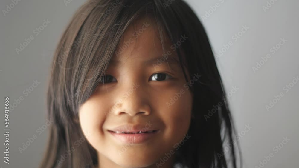 Portrait of Asian girl looking at camera and smiling Portrait of Asian girl looking at camera and smiling