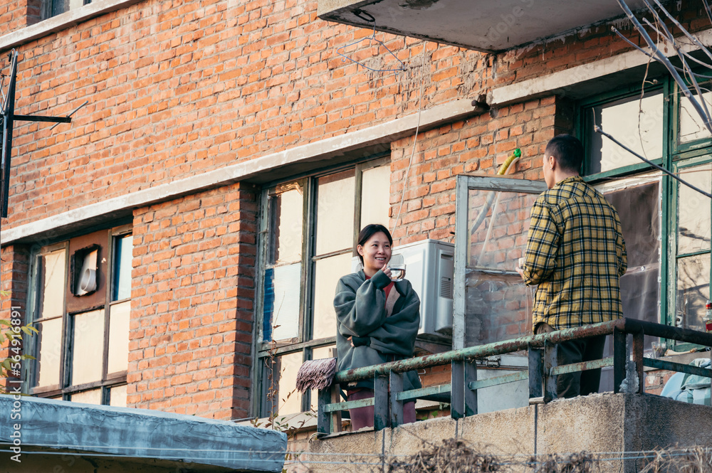 Couple drinking on a balcony Couple drinking on a balcony