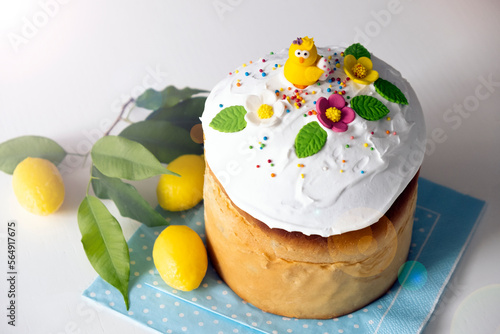 Easter table with traditional dessert of sweet cake with sugar icing and yellow eggs. Happy Easter greeting card. Spring postcard for Easter holidays.