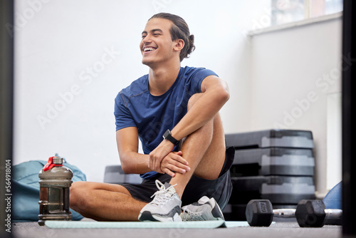 Fototapeta Naklejka Na Ścianę i Meble -  Fitness, relax or happy sports man at gym after training, workout or exercise resting on a break. Tired, smile or healthy athlete with fatigue relaxing on a mat alone after exercising for body goals