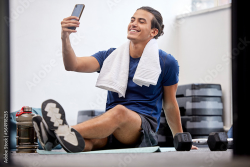 Fitness, happy man and selfie for social media or profile picture with towel after workout exercise or training at gym. Sporty male vlogger or influencer with smile in happiness for online vlog post photo