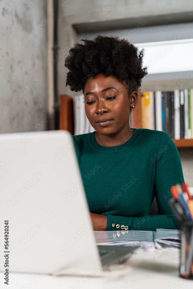 Young Black Woman Working At Her Desk Young Black Woman Working At Her Desk