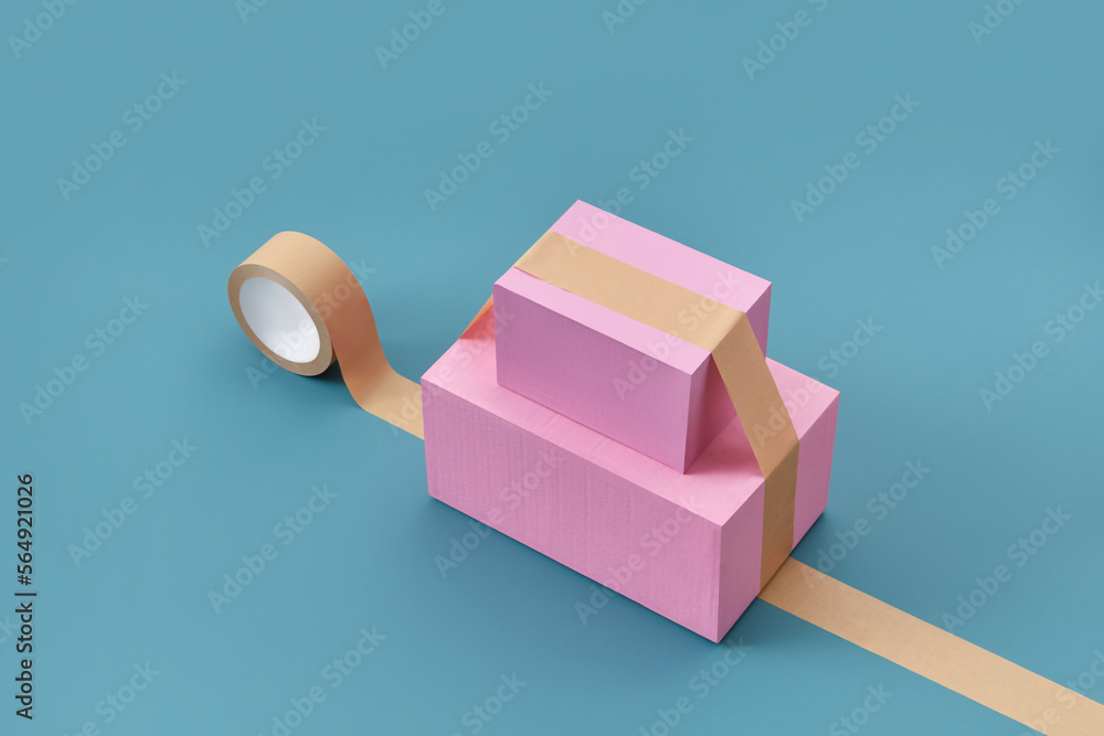 Two pink parcels stuck with packing tape. Stock Photo Adobe Stock