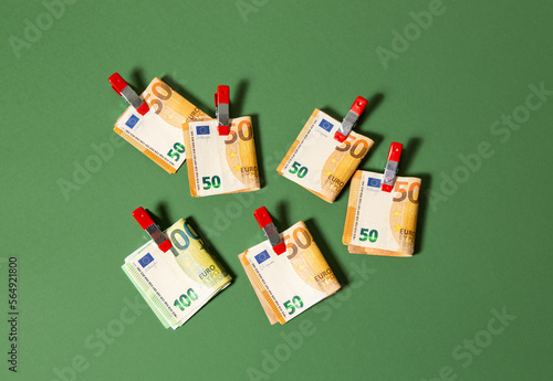 50 and 100 euro notes clipped together on a green background