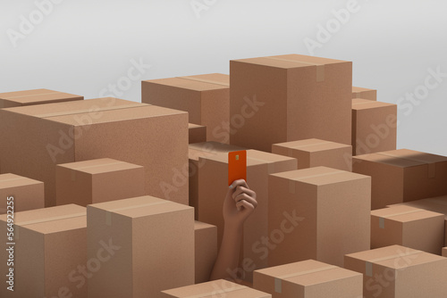 Hand showing credit card surrounded by cardboard boxes photo