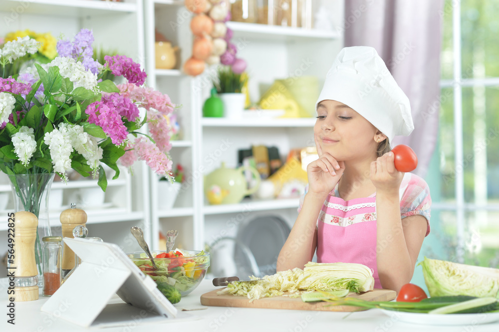 little girl making dinner on kitchen table at home little girl making dinner on kitchen table at home