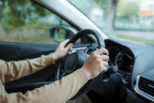 Male driver hands holding steering wheel photo