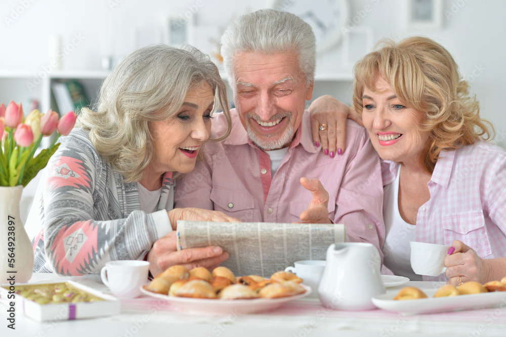 Senior people drinking tea and reading newspaper Senior people drinking tea and reading newspaper
