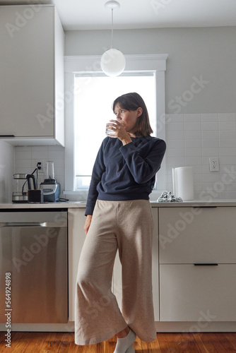 Happy young woman in her new kitchen photo