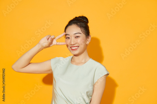 Portrait of funny carefree girl hand fingers demonstrate v-sign photo