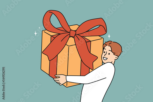 Overjoyed young man holding huge wrapped gift in hands excited with birthday celebration. Smiling guy with present greeting or congratulating. Vector illustration. 
