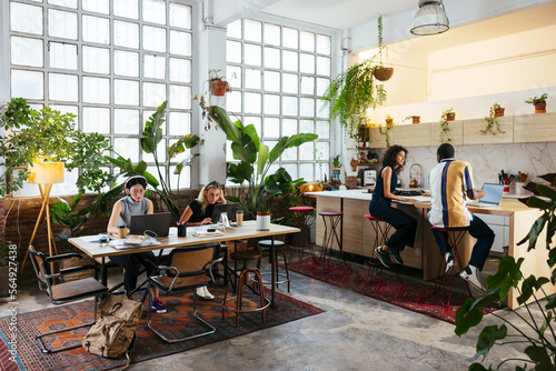 Group of colleagues working on creative workspace