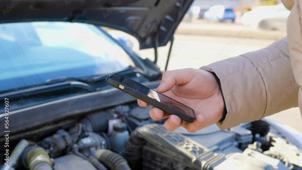 A driver frantically making a call for assistance on his mobile phone, A driver frantically making a call for assistance on his mobile phone,