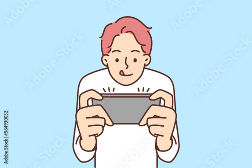 Boy play video game on mobile phone
