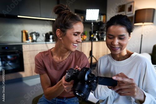 Two female women checking records on the camera