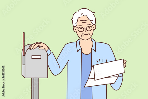 Unhappy old man dissatisfied with letter in mailbox 