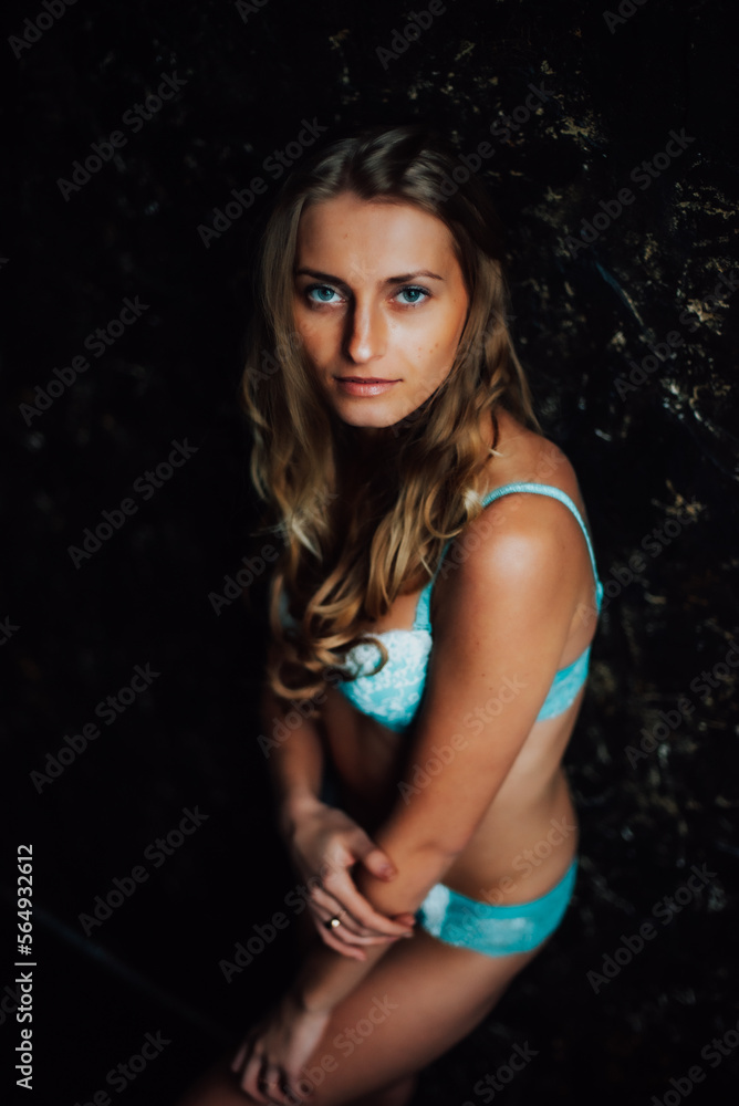 Fototapeta premium tanned girl in blue lingerie. beautiful figure