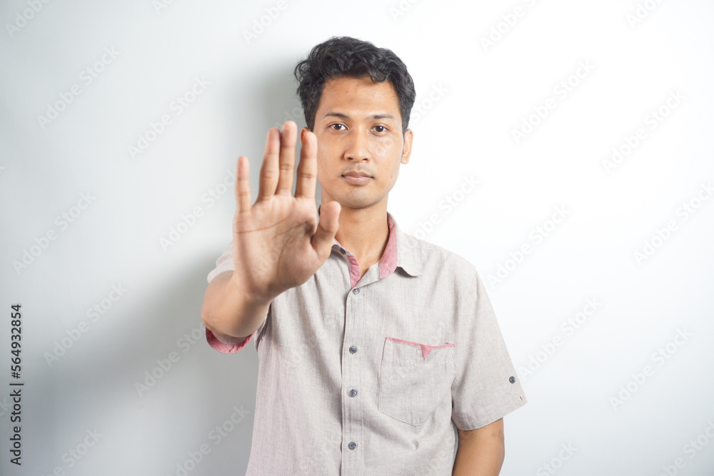 Man over isolated white background making stop gesture with her hand Man over isolated white background making stop gesture with her hand